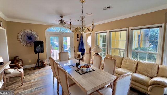 dining room with crown molding, french doors, ceiling fan, and light hardwood / wood-style floors