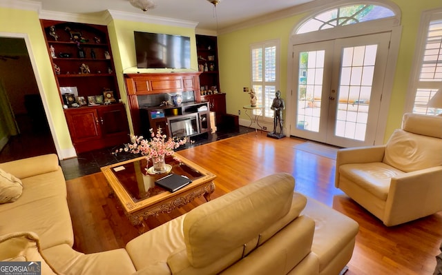 living room with crown molding, a healthy amount of sunlight, and dark wood-type flooring