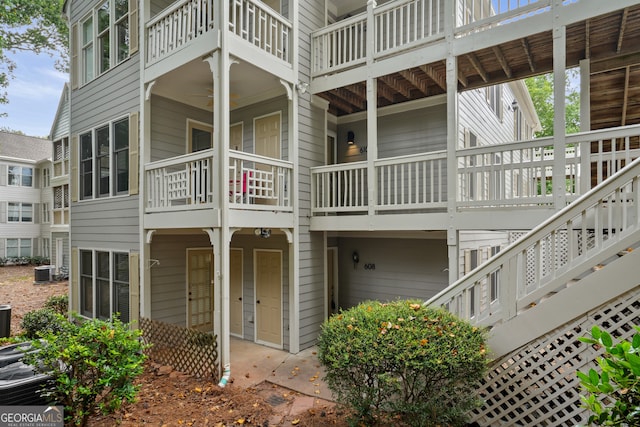 back of house featuring a balcony and central AC unit