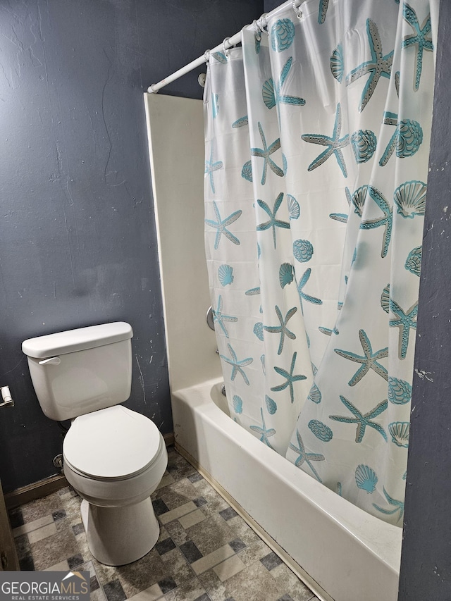 bathroom with toilet and shower / tub combo with curtain