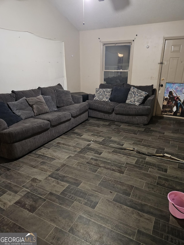 living room featuring ceiling fan and lofted ceiling