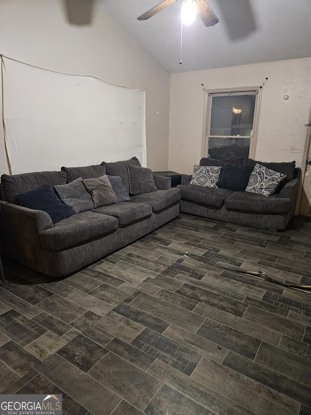 living room with ceiling fan and vaulted ceiling