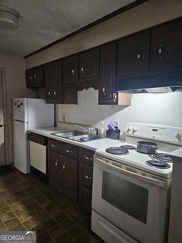 kitchen with sink, dark brown cabinets, tasteful backsplash, and white appliances