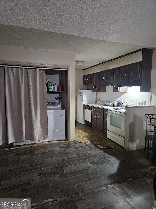 kitchen featuring washer / clothes dryer, white appliances, a textured ceiling, dark brown cabinetry, and sink