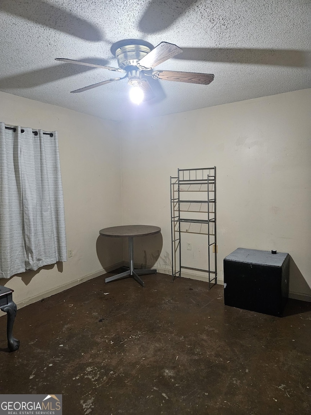 interior space featuring a textured ceiling and ceiling fan