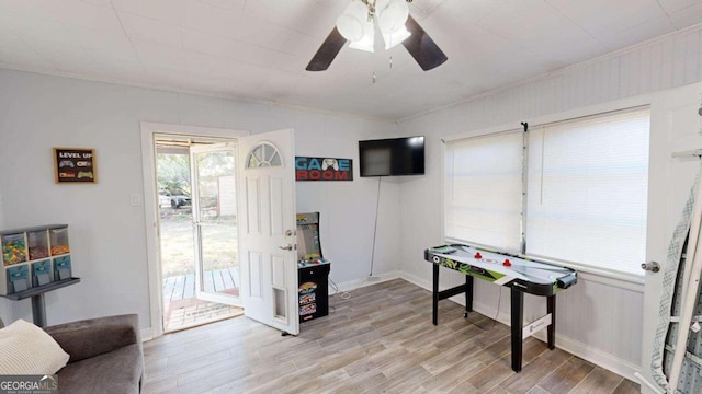 game room featuring light wood-type flooring and ceiling fan