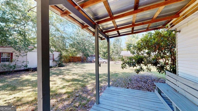 wooden terrace featuring a yard