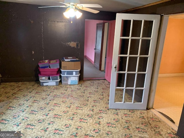 interior space with ceiling fan and carpet floors