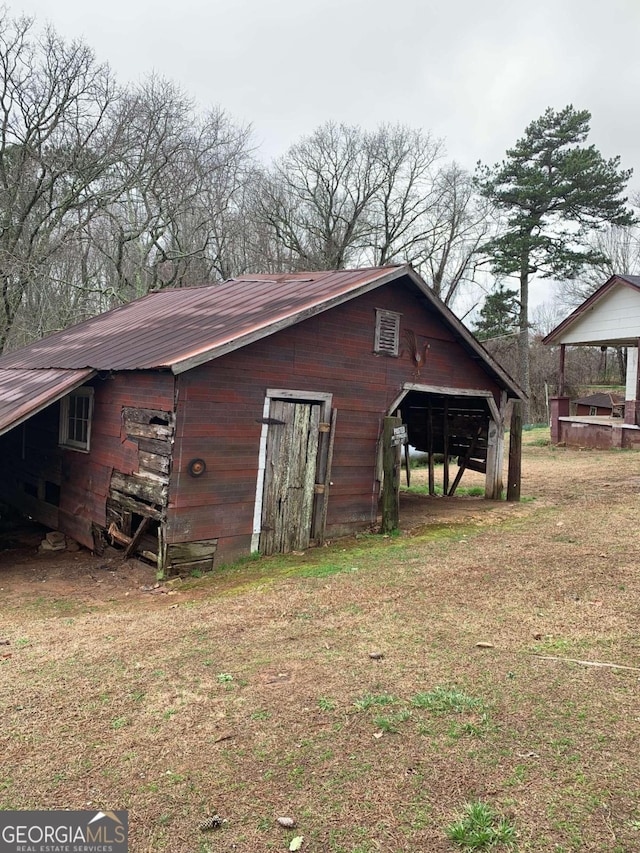 view of outbuilding featuring a yard