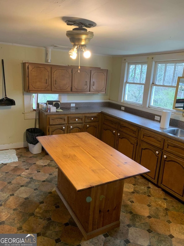 kitchen featuring a center island, sink, and wood counters