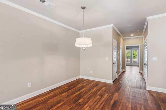 unfurnished dining area featuring baseboards, visible vents, dark wood finished floors, and french doors