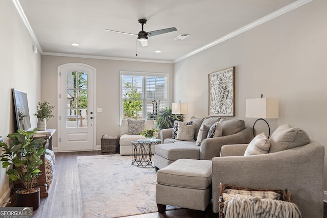 living room with visible vents, a ceiling fan, wood finished floors, crown molding, and recessed lighting