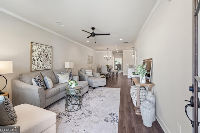 living room with baseboards, ornamental molding, wood finished floors, ceiling fan with notable chandelier, and recessed lighting