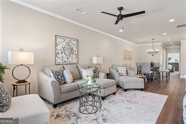 living room with ornamental molding, recessed lighting, visible vents, and wood finished floors