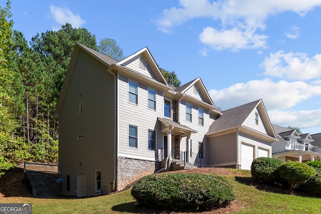 view of front of home featuring a front lawn and a garage