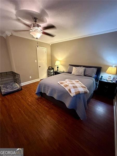 bedroom with ornamental molding, dark hardwood / wood-style flooring, and ceiling fan