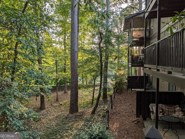 view of yard with a balcony