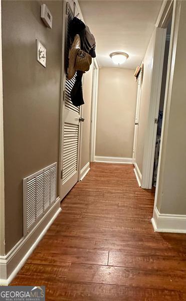 corridor with dark hardwood / wood-style floors