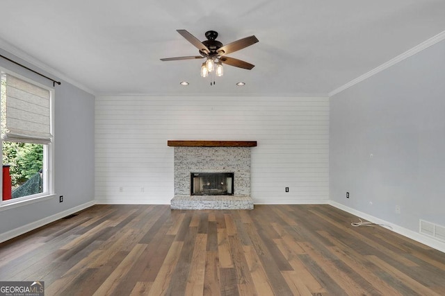 unfurnished living room with wood walls, ceiling fan, dark hardwood / wood-style floors, and ornamental molding