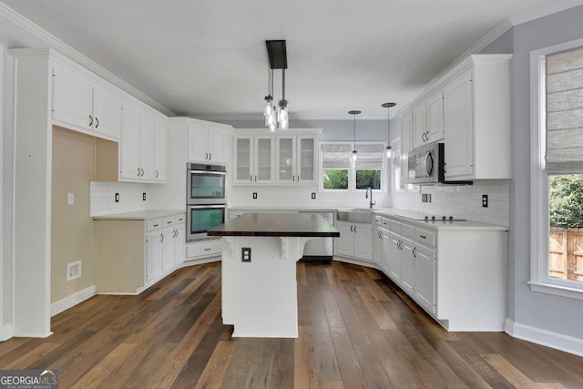 kitchen featuring appliances with stainless steel finishes, white cabinetry, and a kitchen island