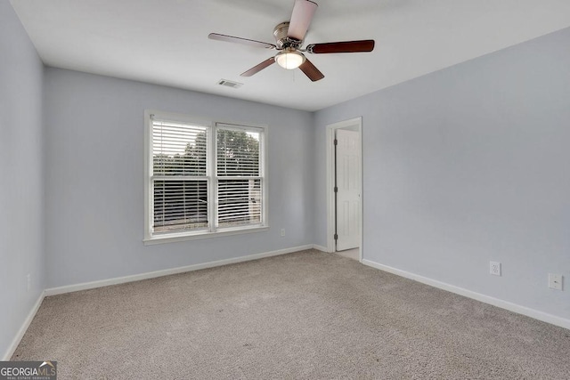 empty room featuring light carpet and ceiling fan