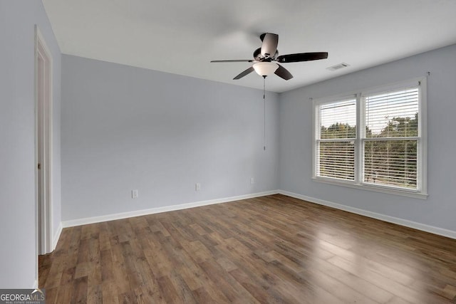 unfurnished room featuring ceiling fan and dark wood-type flooring