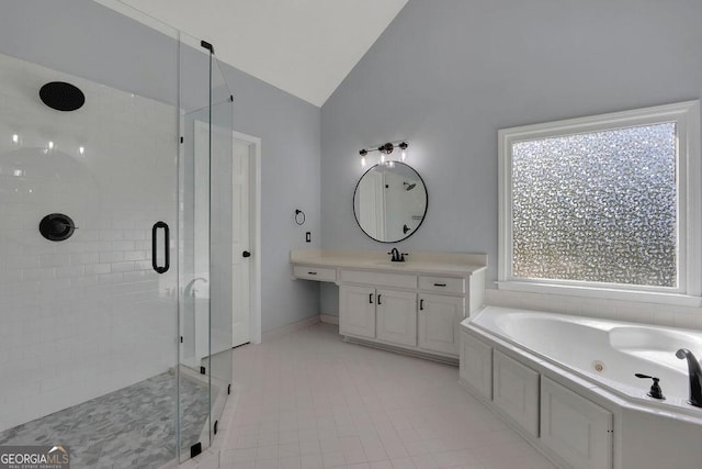 bathroom featuring tile patterned floors, vanity, separate shower and tub, and lofted ceiling