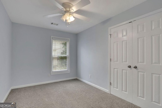 carpeted empty room with ceiling fan