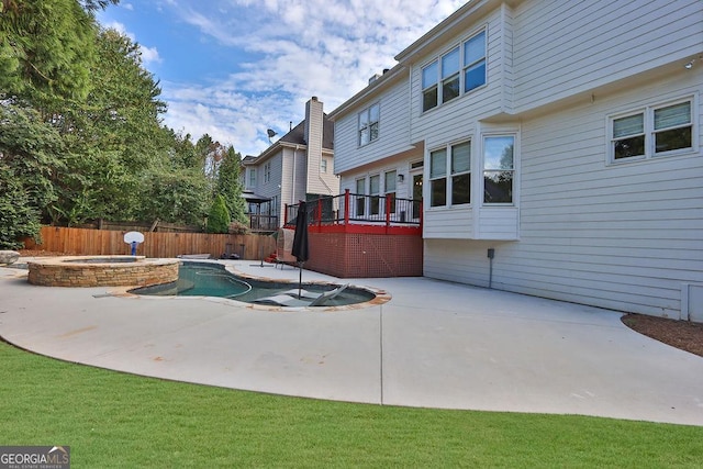 view of pool with an in ground hot tub, a patio area, and a wooden deck