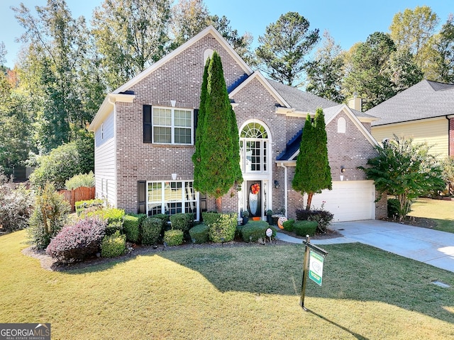 view of front property featuring a front lawn and a garage