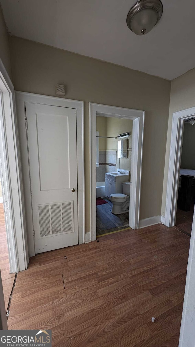 hallway with hardwood / wood-style floors