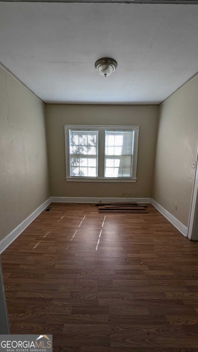 empty room with dark hardwood / wood-style floors