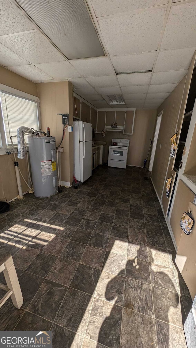 basement featuring a paneled ceiling, electric water heater, and white refrigerator