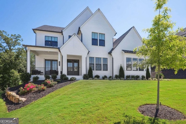 view of front of property featuring covered porch and a front yard