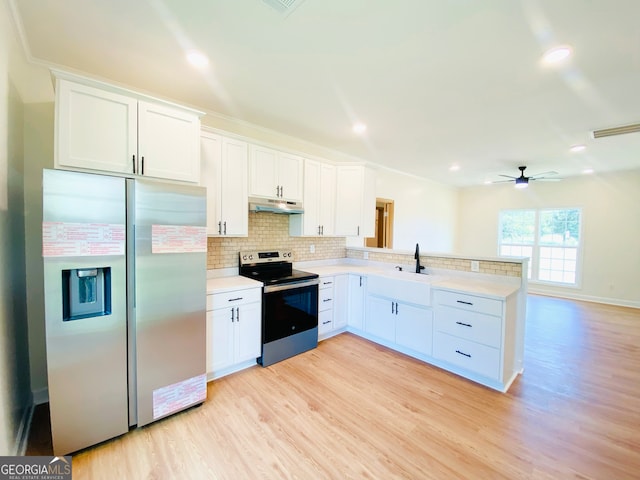 kitchen featuring decorative backsplash, white cabinetry, appliances with stainless steel finishes, and light hardwood / wood-style flooring