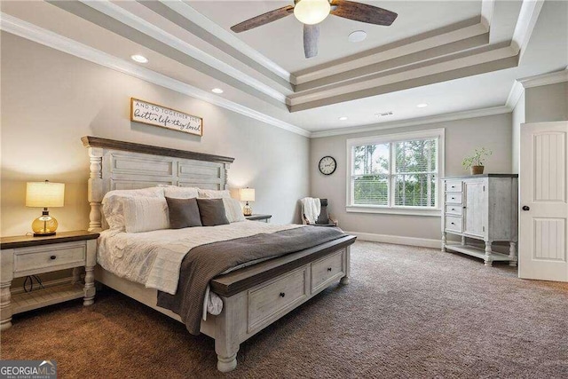 carpeted bedroom featuring a tray ceiling, ceiling fan, and ornamental molding