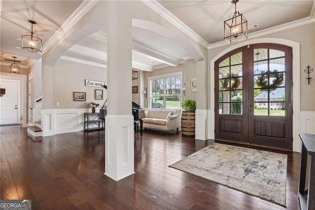 entryway featuring dark hardwood / wood-style floors, beam ceiling, crown molding, and french doors