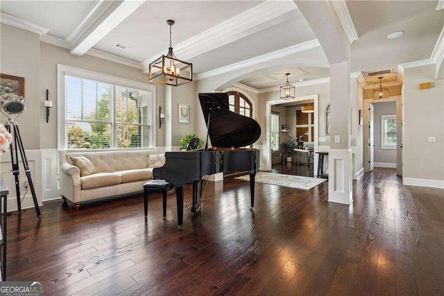 interior space with dark hardwood / wood-style flooring, crown molding, and a wealth of natural light