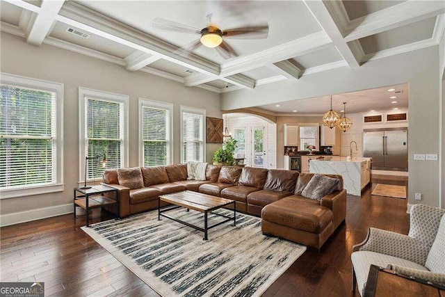 living room featuring plenty of natural light, dark wood-type flooring, and coffered ceiling