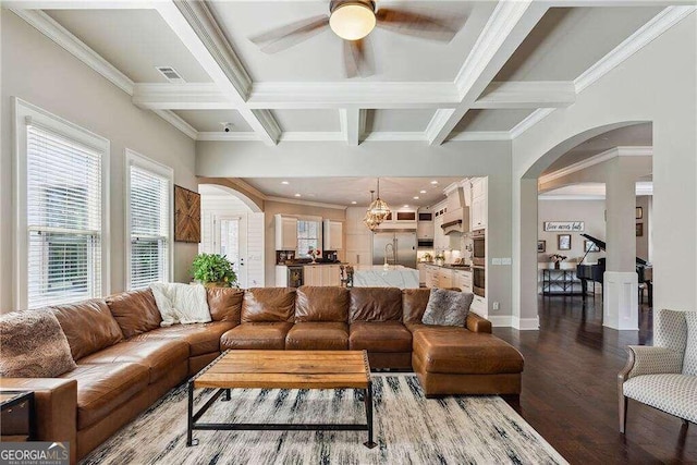 living room featuring hardwood / wood-style floors, ornamental molding, and coffered ceiling