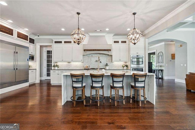 kitchen with dark hardwood / wood-style flooring, stainless steel appliances, and decorative light fixtures