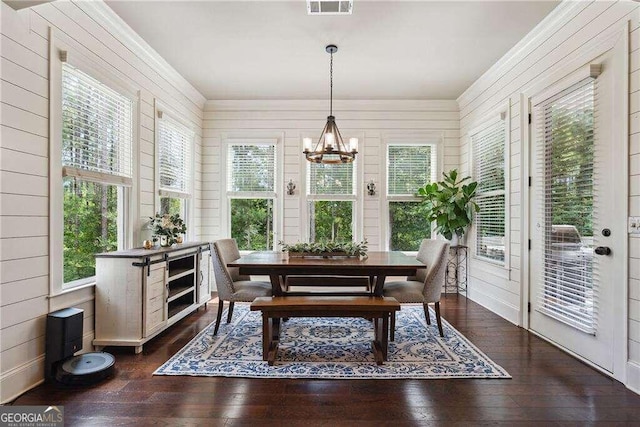 sunroom with a chandelier