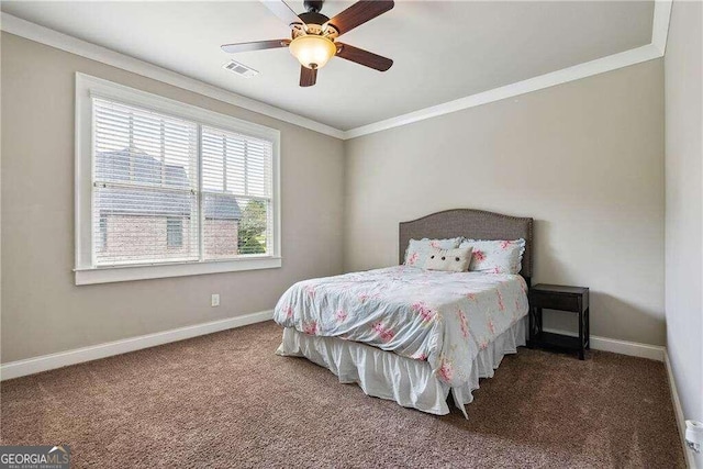 carpeted bedroom with ceiling fan and ornamental molding