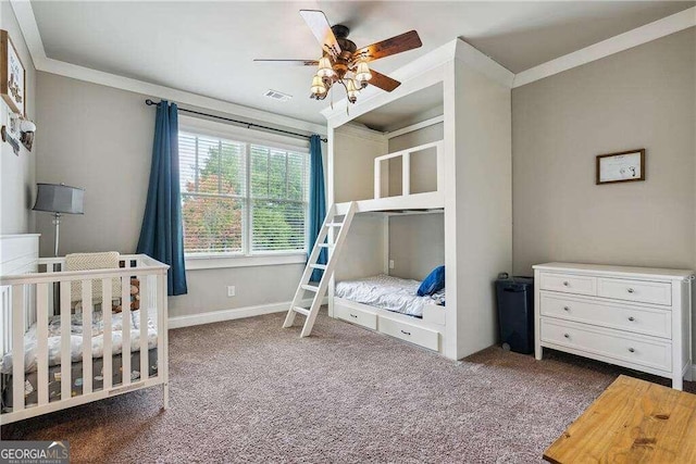 bedroom featuring carpet flooring, ceiling fan, crown molding, and a crib