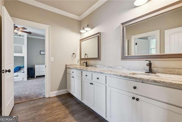 bathroom featuring ceiling fan, crown molding, vanity, and hardwood / wood-style flooring