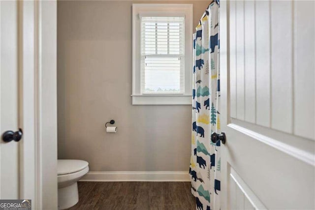 bathroom with hardwood / wood-style flooring and toilet