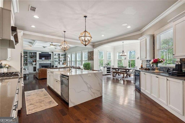 kitchen featuring dark stone counters, dark wood-type flooring, and pendant lighting