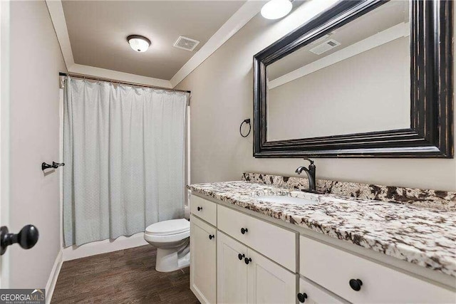 full bathroom featuring hardwood / wood-style floors, vanity, toilet, and shower / bath combination with curtain