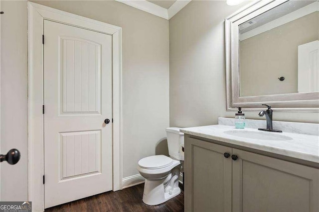 bathroom featuring vanity, wood-type flooring, and toilet