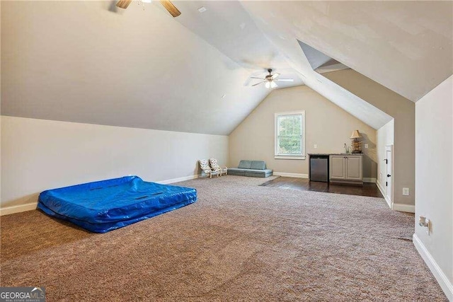 additional living space featuring ceiling fan, lofted ceiling, and carpet floors